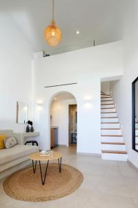 a living room with a couch and a table at Adorno Oia in Oia
