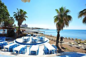 uma praia com cadeiras azuis e brancas e o oceano em Lara Beach 600 m, 80 m2 flat, 2 bedroom, Netflix em Antalya