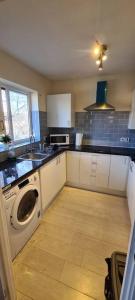a kitchen with a washer and dryer in it at Private 2 Bed Flat close to EXCEL & CITY AIRPORT in London