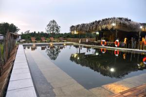 einen Pool mit Wasser, um den die Leute herumstehen in der Unterkunft TimeOut Island Glamping Resort in Ấp Binh Trung