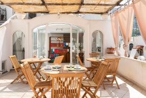 a patio with tables and chairs and a book shelf at alle Stelle b&b in Anacapri