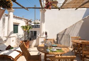 a patio with tables and chairs on a balcony at alle Stelle b&b in Anacapri