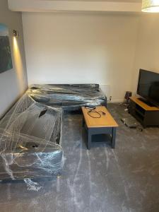 a room with a bed and a table and a tv at May Disc - Long Stay - Contractors in Bristol