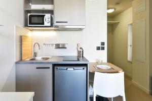 a small kitchen with a sink and a microwave at Student Factory Toulouse Zénith in Toulouse