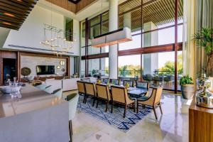 an open kitchen and dining room with a table and chairs at The Estates Four Bedroom Loft E1- Nuevo Vallarta in Mesas de Picachos