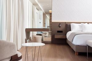 A bed or beds in a room at Mediterranean Hotel