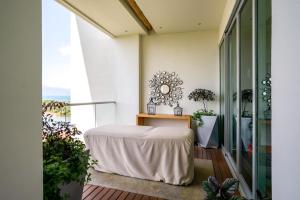 a room with a table and a mirror on the wall at Grand Luxxe Two Bedroom Spa Suite- Nuevo Vallarta in Nuevo Vallarta