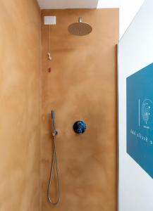 a shower in a room with a wooden wall at alle Stelle b&b in Anacapri