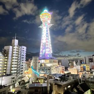 a ferris wheel tower in a city at night at HOTEL AARON通天東 in Osaka