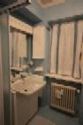 a bathroom with two sinks and a radiator at Campiglio Tre Sassi in Madonna di Campiglio