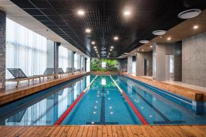 a large swimming pool in a building at Lovely apartment by the sea. in Ķesterciems