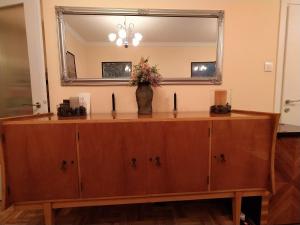 a dresser with a mirror and a vase on it at Cozy three BDRMS central APT at five Filippou str in Thessaloniki