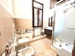 a bathroom with a toilet and a sink and a shower at Sealovers house Deluxe in Civitavecchia