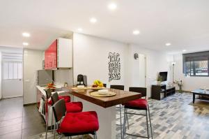 a kitchen and living room with a table and chairs at San Fernando Apartment in San Bartolomé