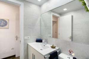 a bathroom with a sink and a mirror at San Fernando Apartment in San Bartolomé