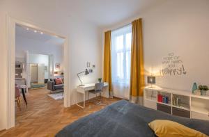 a bedroom with a bed and a desk in a room at Cosy City Center Apartment in Vienna