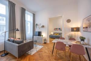 a living room with a table and chairs and a couch at Cosy City Center Apartment in Vienna