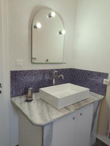 a bathroom with a white sink and a mirror at Riverhouse Žeger in Prijedor