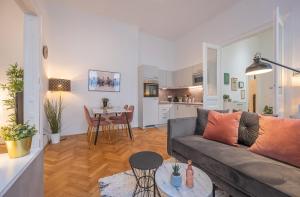 a living room with a couch and a table at Cosy City Center Apartment in Vienna +12 photos