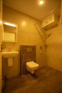 a bathroom with a toilet and a sink at Teaberg Estate Haus in Munnar