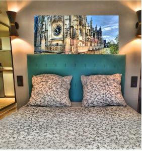 a bedroom with a bed with a painting on the wall at suite st lo 2 in Rouen