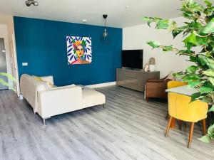 a living room with a couch and a tv at Stunning huge openplan 2Bed flat in Woking