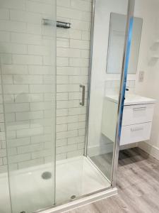 a shower with a glass door in a bathroom at Stunning huge openplan 2Bed flat in Woking