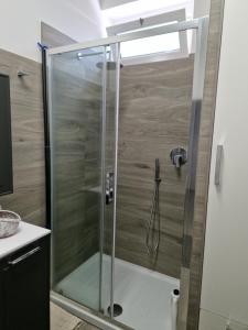 a shower with a glass door in a bathroom at Susy's Home Appartamento in centro in Corchiano +12 photos