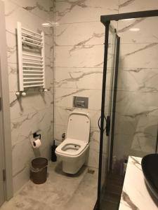 a bathroom with a white toilet in a room at Comfortable accommodation and nearby attractions in Istanbul