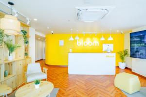 an office with a yellow wall and a reception desk at Bloom Hotel - Cyber Towers in Hyderabad
