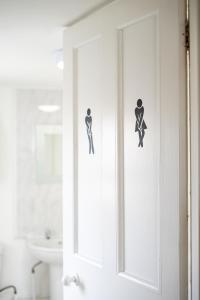 a bathroom door with two stickers on it at Cheltenham-2 Bed House-Sleep 6-Parking-Garden-Wifi in Cheltenham