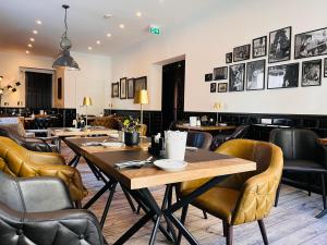 un restaurante con mesas de madera y sillas de cuero en HOTEL CENTRAL FULDA, en Fulda