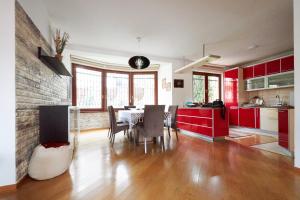 a kitchen and dining room with red cabinets and a table at Villa Center Sarajevo - FREE PARKING in Sarajevo