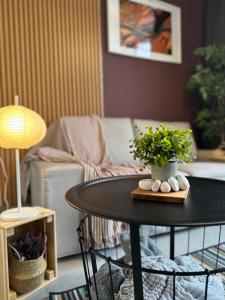 a living room with a table with a plant on it at Eco Kanvas Soho Suites in Cyberjaya