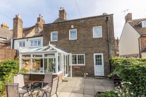 an extension to a brick house with a conservatory at Chimneys in Poole