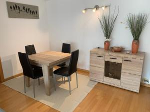 a dining room with a wooden table and chairs at APARTAMENTO NUEVA CONSTRUCCIÓN EN CENTRO CALELLA in Calella