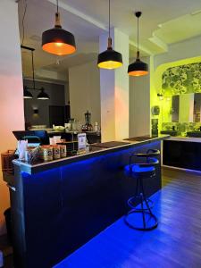 a kitchen with a blue bar with two stools at The Base Inn Pattaya in Pattaya Central