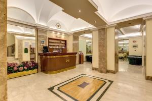 a lobby with a reception desk in a building at Hotel Igea in Rome