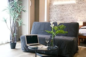 a laptop on a coffee table in front of a couch at The Masters Stay SETAGAYA KYODO in Tokyo