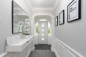 a hallway with white walls and a white door at Riversleigh 