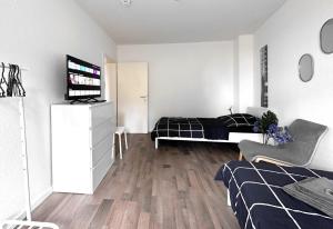a bedroom with a bed and a television in it at #VAZ Apartments RS06 Küche, WLAN, TV, Balkon in Remscheid