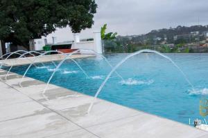 a group of water fountains in a swimming pool at Standard Room in Cape Coast - Lakeview by Agnes in Cape Coast