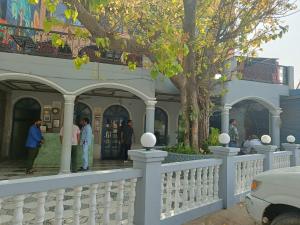 a white fence in front of a house at Maya Hotel & Restaurant in Agra