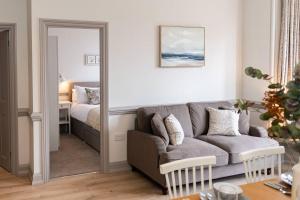 a living room with a couch and a bedroom at 3 Castle Mews in Salisbury