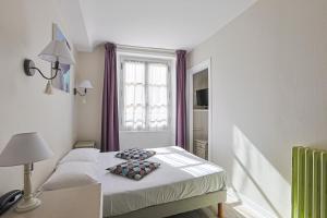 Postel nebo postele na pokoji v ubytování Hôtel François d'O