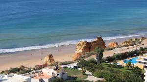 a view of a beach with people on the sand at Casa Jardins da Rocha in Portimão