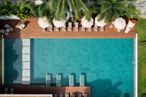 an overhead view of a swimming pool with chairs and trees at Chi Samui Resort in Bophut