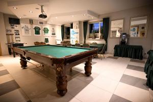 a room with a pool table on a tiled floor at Hostel CENTRUM in Radom