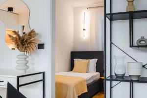 a bedroom with a bed and a mirror at Apartma Vila Center LUX in Slovenj Gradec