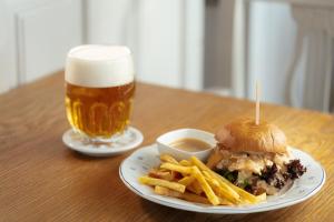 een broodje en frietjes en een glas bier bij Hotel Zámeček Janovičky in Broumov